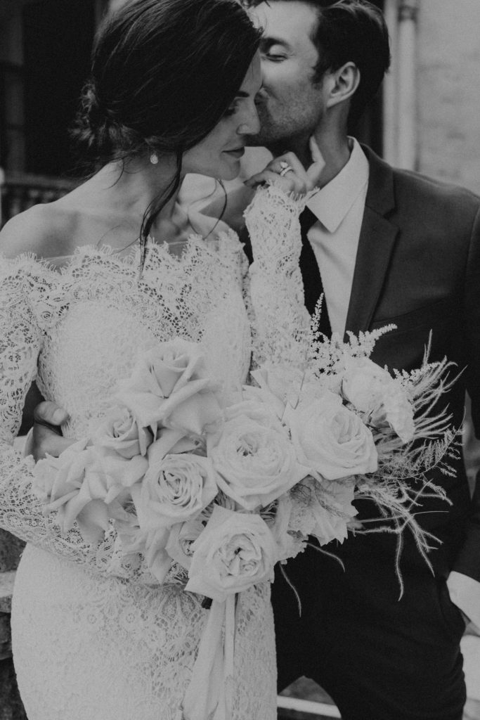 Black and white intimate portrait of bride and groom on their wedding day.