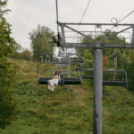 Bride and groom riding the chairlift from Rib Mountain Amphitheater ceremony to their reception at the Sundance Chalet.